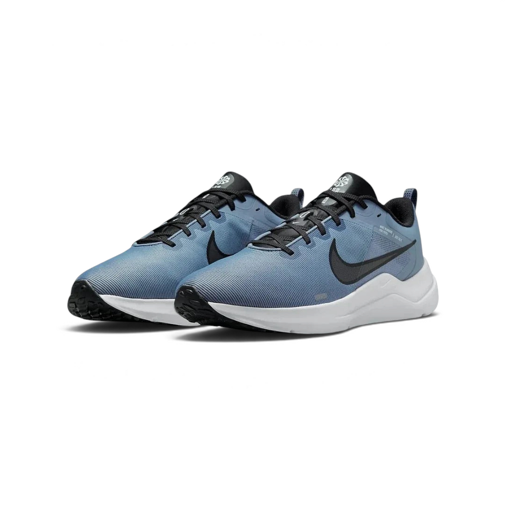Angled view of two Nike Downshifter 12 Men's grey and black training shoes, side by side, showcasing their versatile design and cushioned profile.