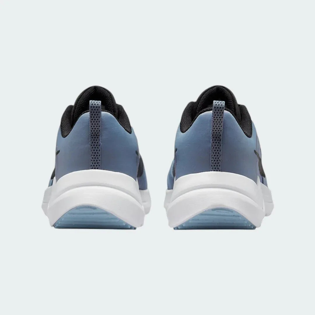 Rear view of the Nike Downshifter 12 Men's grey training shoes, focusing on the structured heel and subtle branding.