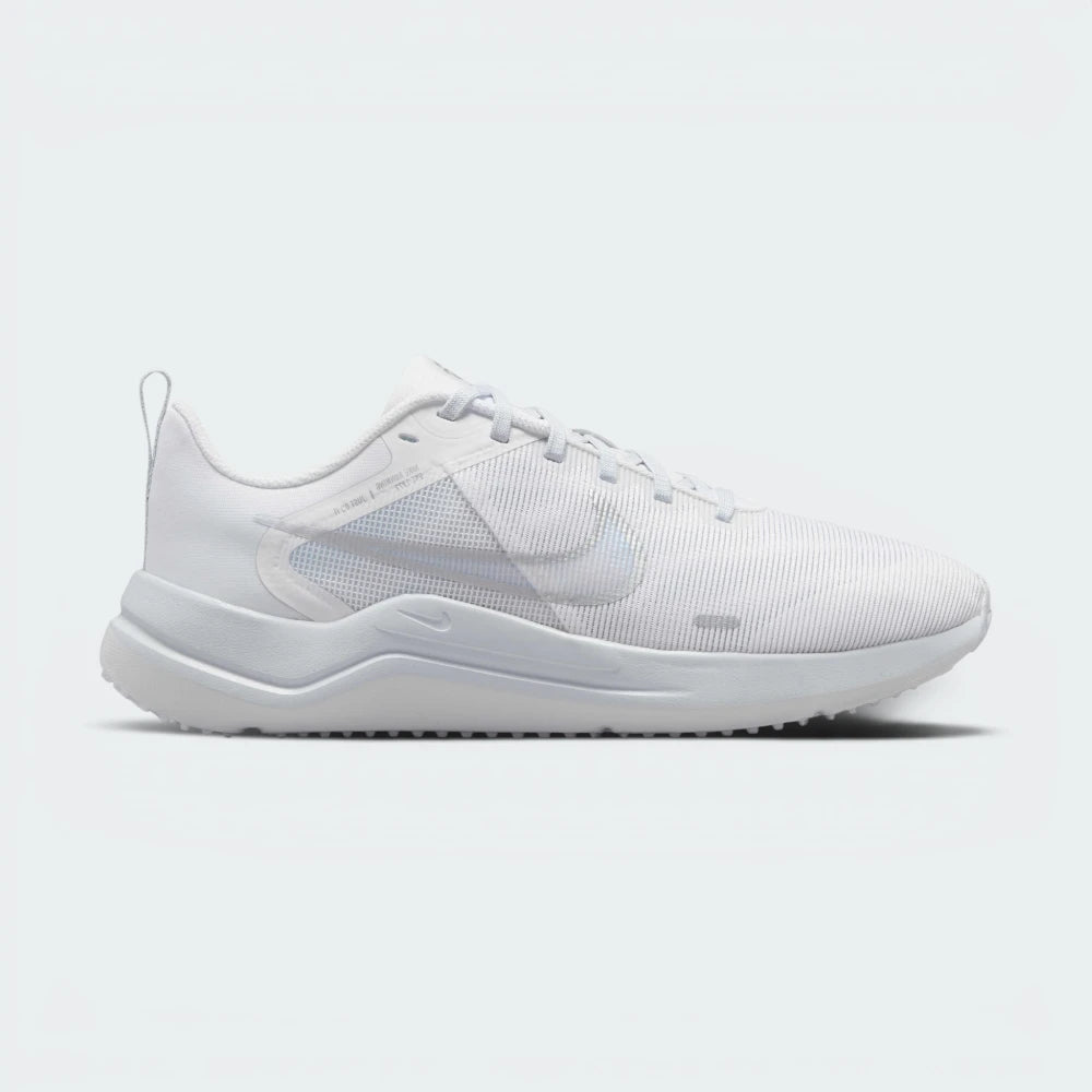 Highlights the high-velocity Metallic Silver Nike Swoosh slashing across the professional depth of the Pure Platinum mesh upper and the sculpted white midsole wall.