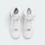 Focuses on the locked-in traditional lacing layout, displaying the perfect symmetry of the white textile tongue, the classic metal lace dubrae, and the neat rows of perforations guarding the front toe box area.