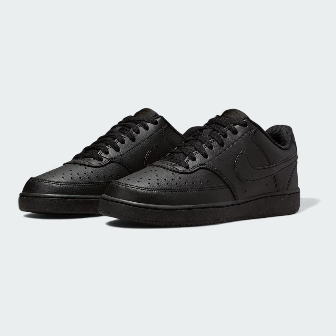 Angled view of two Nike Court Vision Lo Next Nature Men's black trainers, side by side, showcasing their clean aesthetic and retro style.