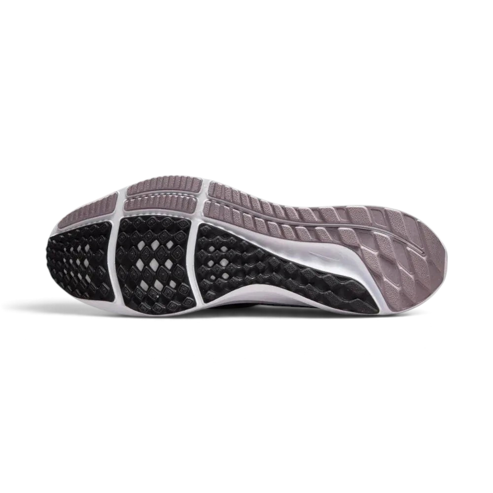 View of the black rubber outsole, showcasing the waffle-inspired lugs designed for grip on asphalt and pavement.
