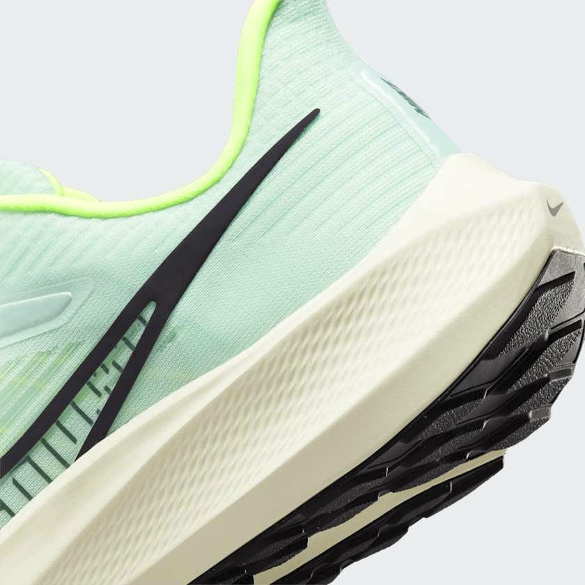 Detailed zoom on the outsole and midsole of the Nike Air Zoom Pegasus 39 Men's green running trainers, highlighting the responsive React foam and visible Zoom Air units.