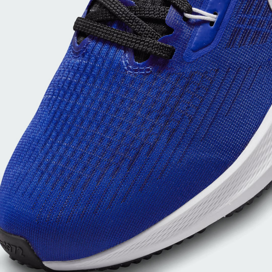 Close-up zoom on the front of the Nike Air Zoom Pegasus 39 Men's blue running trainers, showing the breathable engineered mesh texture and integrated lacing system with Flywire cables.