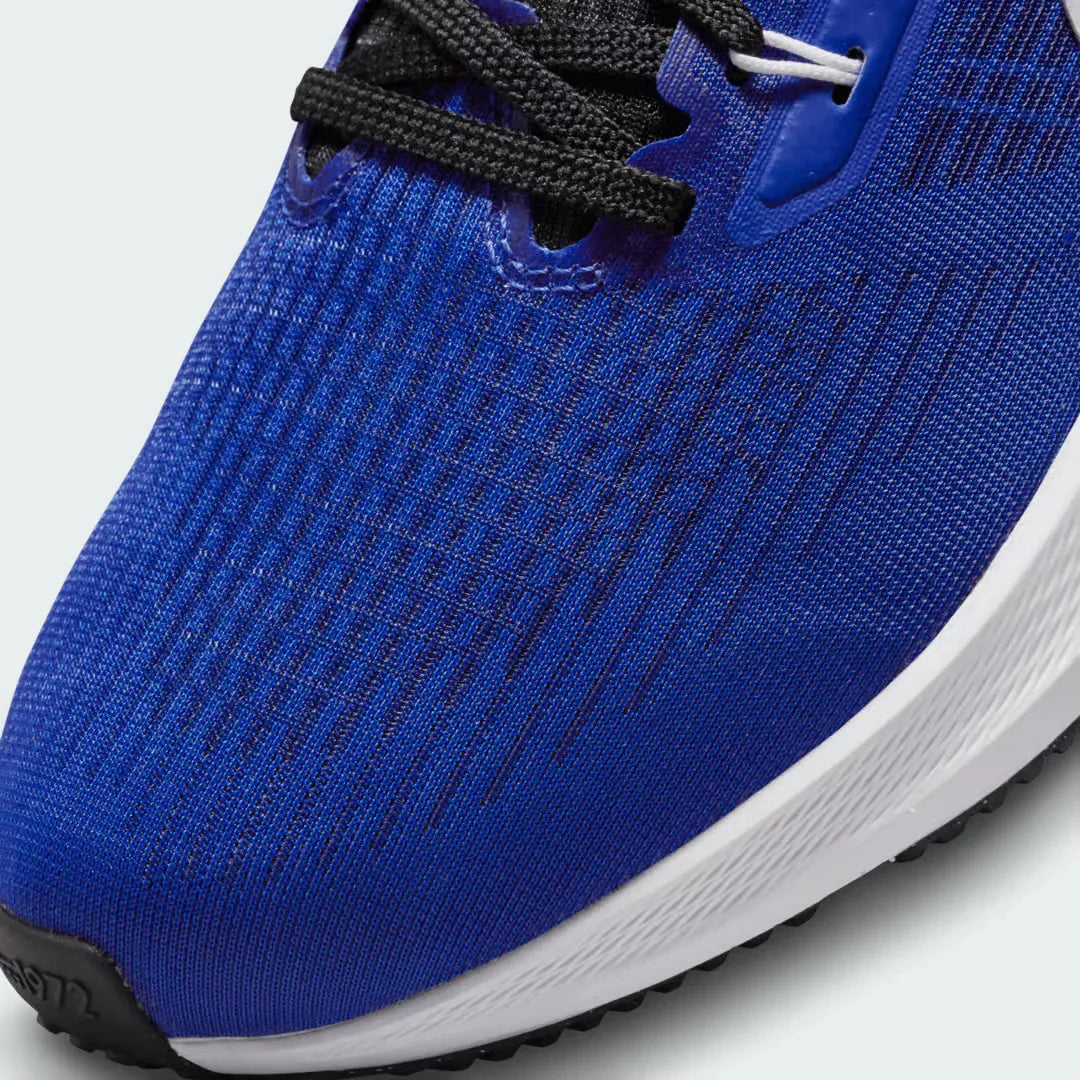 Close-up zoom on the front of the Nike Air Zoom Pegasus 39 Men's blue running trainers, showing the breathable engineered mesh texture and integrated lacing system with Flywire cables.