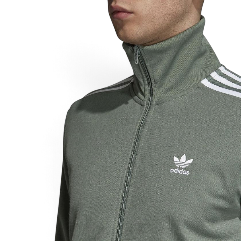 Close-up zoom on the Adidas Beckenbauer Track Jacket Men's, showing the soft doubleknit fabric texture and the detailed embroidered Trefoil logo.