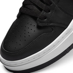 Close-up zoom on the front of the Air Jordan 1 Elevate Low Women's trainers, showing the perforated toe box, lacing system, and textured leather upper.