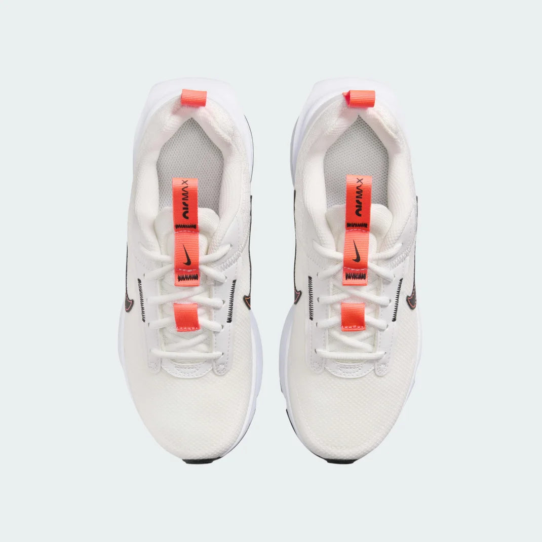 Top-down view of a pair of Nike Air Max Intrlk Lite Juniors' trainers in off-white, highlighting their sleek design and lace-up closure.