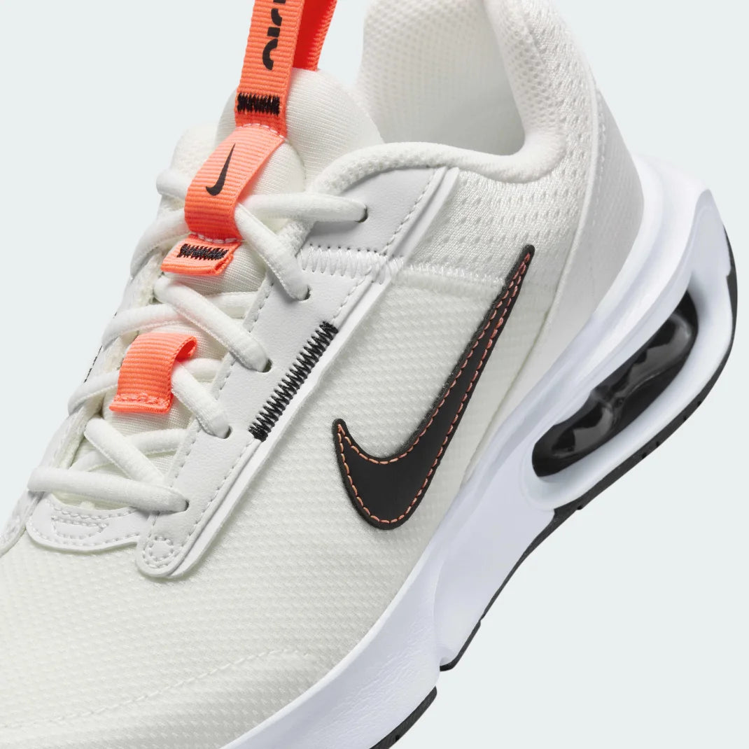 Close-up zoom on the front of the Nike Air Max Intrlk Lite Juniors' trainers, showing the mesh toe box, lacing system, and synthetic overlays.