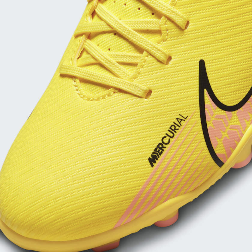 Close-up of Nike Mercurial Vapor 15 Club Juniors Boots DJ5958-780 texture and laces on synthetic upper