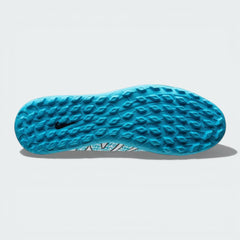 View of the rubber lug outsole, showcasing the aggressive traction pattern specifically engineered for turf surfaces.