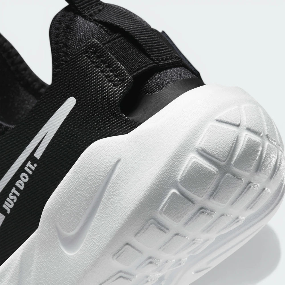 Highlights the springy foam layers and the deep grooves that allow for natural foot flex.