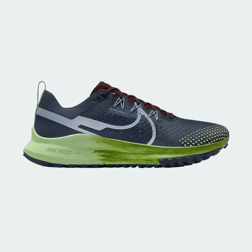 Nike React Pegasus Trail 4 Men's running shoes in shades of thunder blue with light armory blue and green accents, side profile showing engineered mesh upper and rugged rubber outsole. Main image