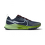 Nike React Pegasus Trail 4 Men's running shoes in shades of thunder blue with light armory blue and green accents, side profile showing engineered mesh upper and rugged rubber outsole.
