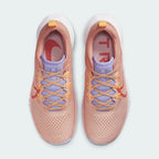 Top-down view of a pair of Nike Pegasus Trail 4 Women's running shoes in pink/orange, highlighting their breathable upper and lace-up closure.
