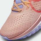 Close-up zoom on the front of the Nike Pegasus Trail 4 Women's pink running shoes, showing the breathable mesh texture, lacing system, and protective toe overlay.