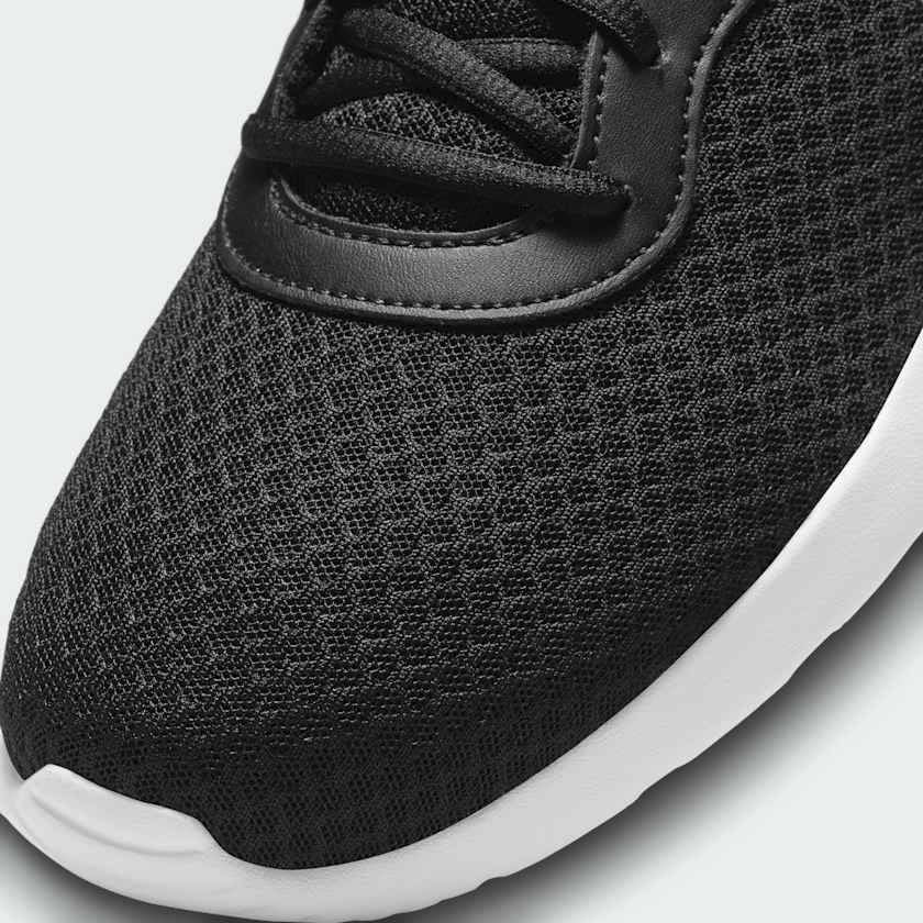 Close-up of Nike Tanjun Men's Black Trainers DJ6258 laces, mesh texture, and collar padding
