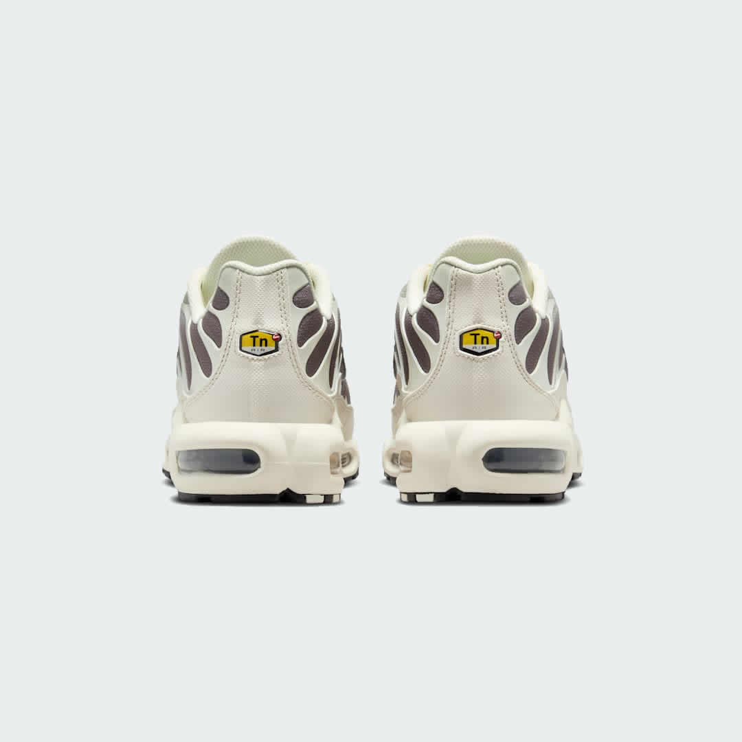 Rear view of the Nike Air Max Plus TN Men's trainers, focusing on the prominent Tuned Air branding on the heel and wavy design elements.