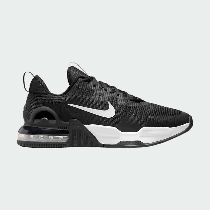 Nike Air Max Alpha Trainer 5 Men's shoes in black with white accents, side profile showing visible Max Air unit in the heel, durable mesh upper, and supportive overlays.