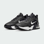 Angled view of two Nike Air Max Alpha Trainer 5 Men's black and white shoes, side by side, showcasing their robust design and stable platform.