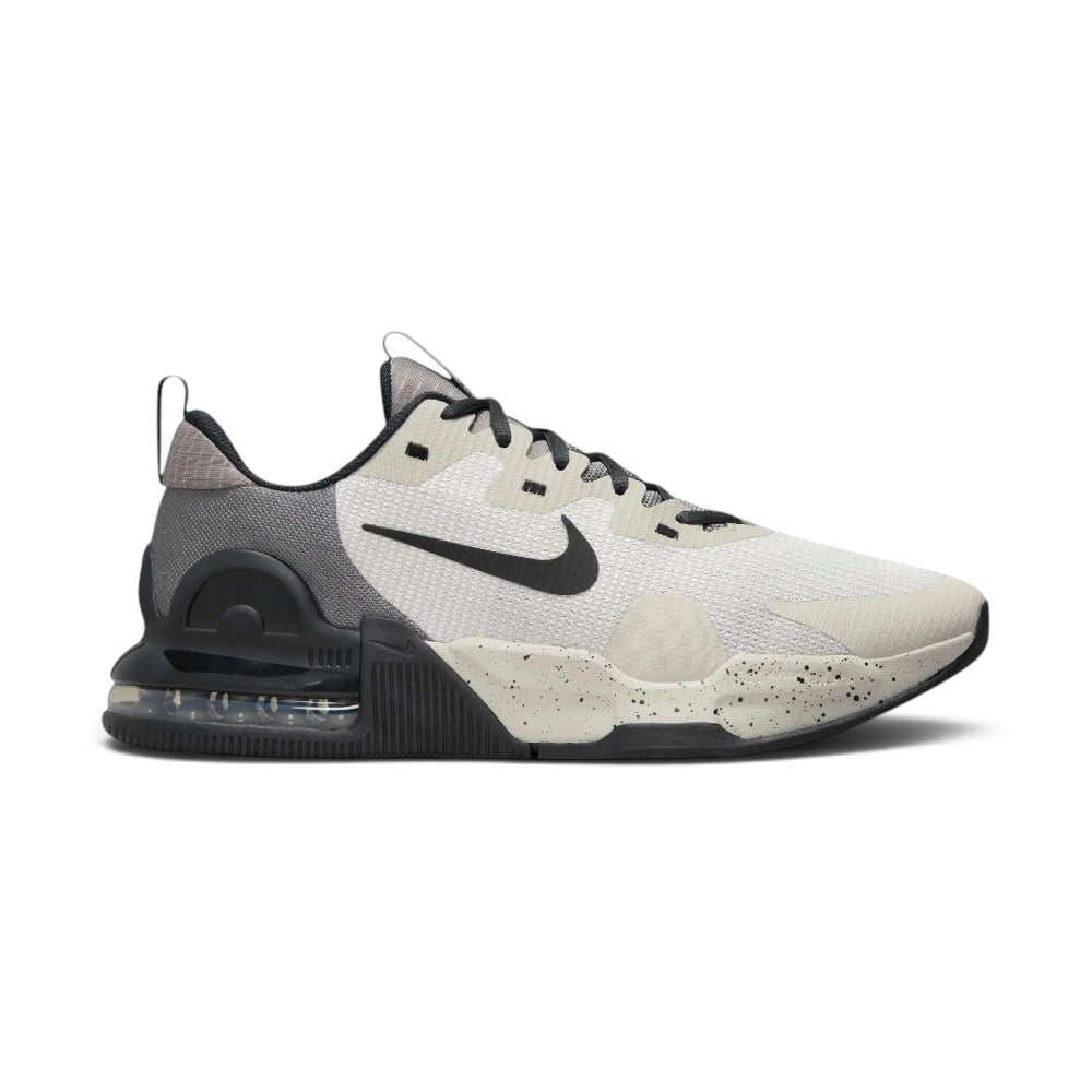 Highlights the high-velocity lines of the visible Max Air unit sitting embedded inside the professional depth of the Light Iron Ore foam midsole wall. Main image