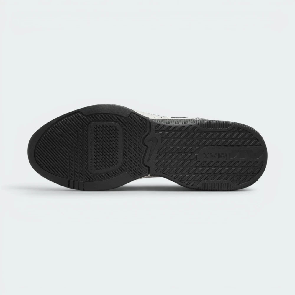 Displays the flat, wide sole and its enhanced rubber tread pattern engineered for unreal multi-surface traction on rubber gym mats.