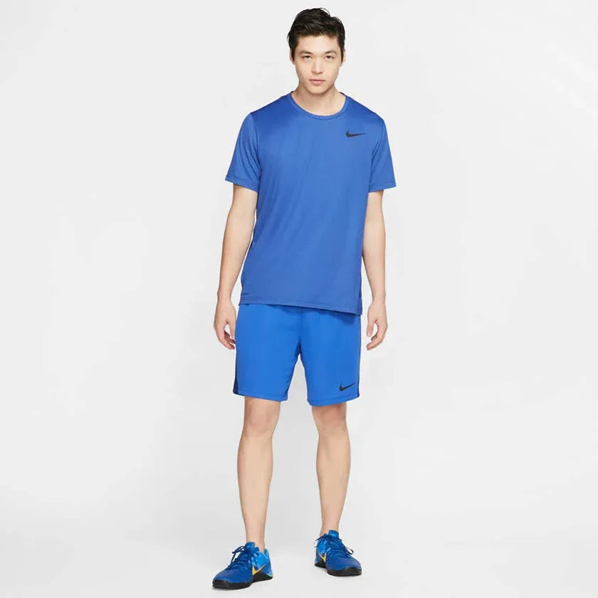Nike Men's Dri-FIT 8" running shorts in obsidian worn by a male runner, side profile highlighting the 8-inch inseam and freedom of movement.