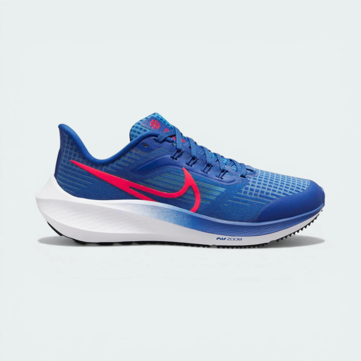 Side profile of the Game Royal blue Nike Pegasus 39 Junior, showing the Bright Crimson Swoosh and the sleek aerodynamic silhouette.