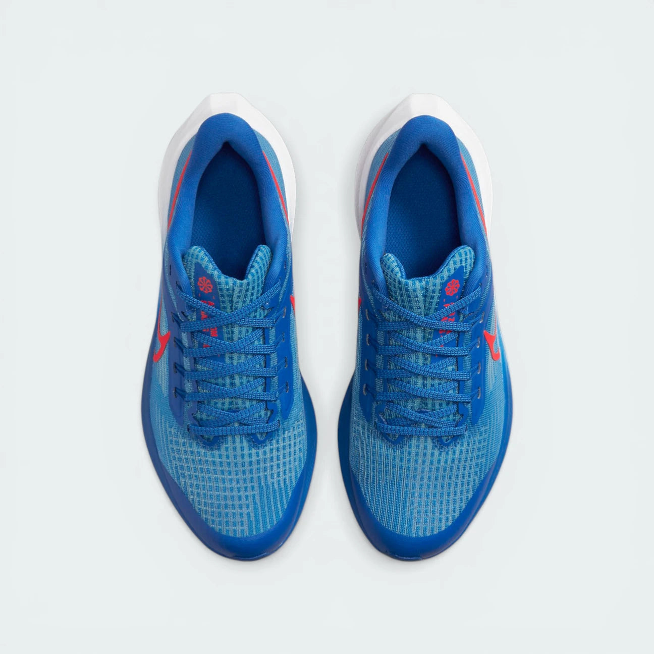 Top-down view of the junior trainers, highlighting the breathable mesh upper and the Bright Crimson lacing accents.