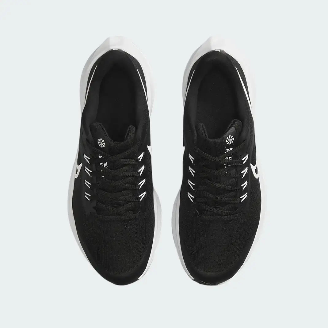 Top-down view of a pair of Nike Air Zoom Pegasus 39 Next Nature running trainers in black and white, highlighting their streamlined silhouette and lace-up closure.
