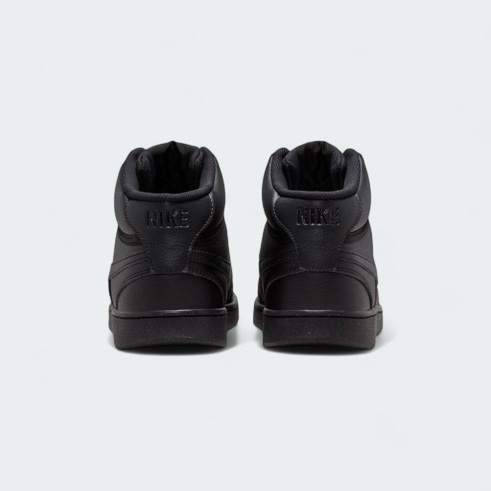Rear view of the Nike Court Vision Mid Next Nature Men's black shoes, focusing on the padded collar and Nike branding on the heel tab.