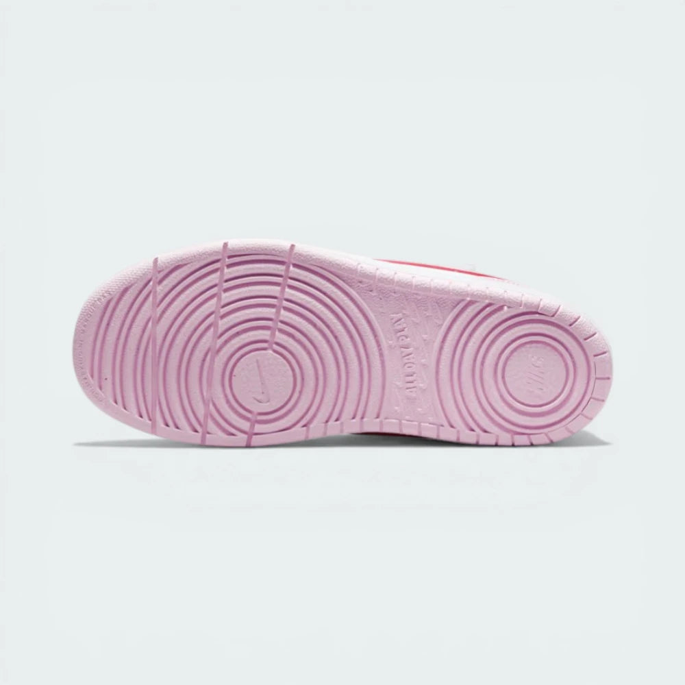 View of the flat pink rubber outsole, emphasising the flexible traction pattern designed for stability.