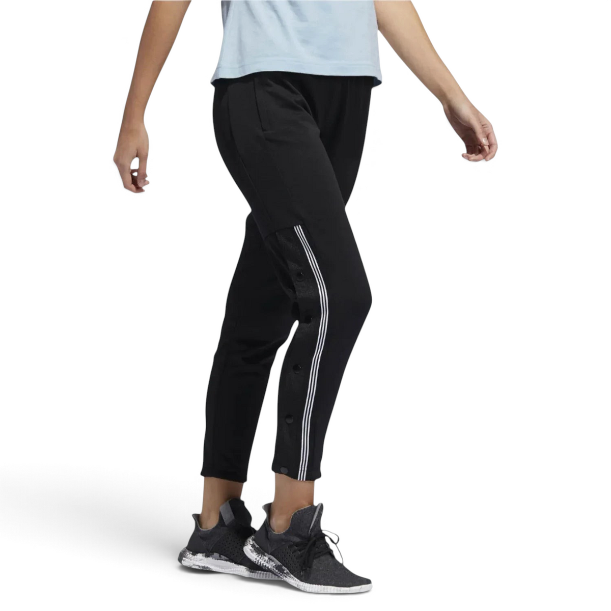 Adidas 7/8 Cropped Snap Pants Women's in black worn by a woman, showcasing the cropped length, side snap details, and relaxed fit in a casual setting. Main image