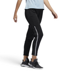 Adidas 7/8 Cropped Snap Pants Women's in black worn by a woman, showcasing the cropped length, side snap details, and relaxed fit in a casual setting.