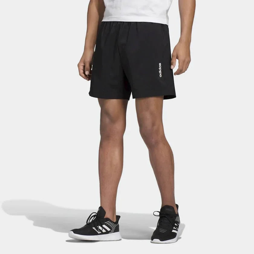 adidas Essentials Men's Chelsea Shorts DQ3085 worn in a standing pose showing athletic fit Main image