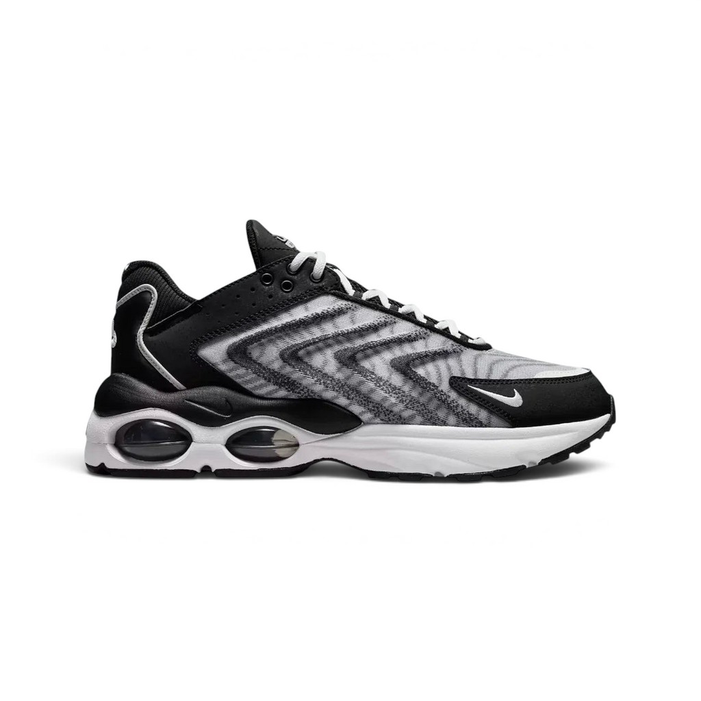 Nike Air Max TW trainers in black and white, side profile showing the layered, angular upper design and the visible Air Max unit with multiple windows in the heel.