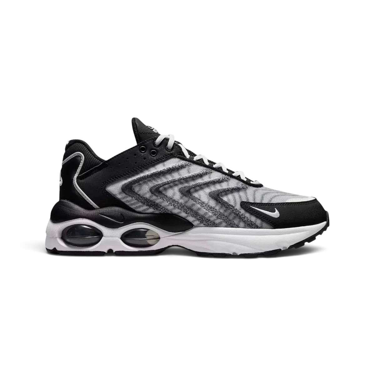 Nike Air Max TW trainers in black and white, side profile showing the layered, angular upper design and the visible Air Max unit with multiple windows in the heel.