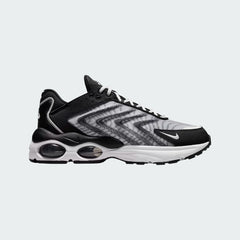 Nike Air Max TW trainers in black and white, side profile showing the layered, angular upper design and the visible Air Max unit with multiple windows in the heel.