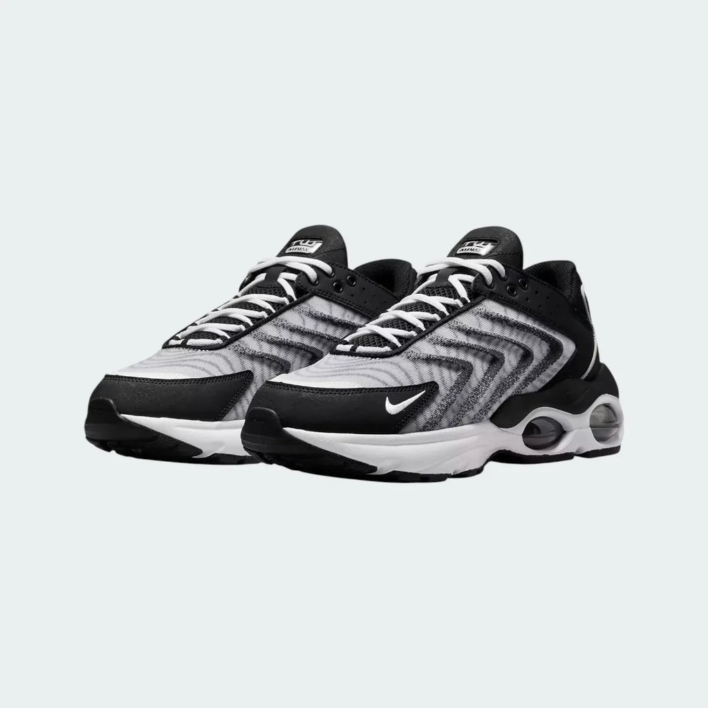 Rear view of the Nike Air Max TW trainers in black, focusing on the prominent, accentuated heel counter and the visible Air cushioning windows.