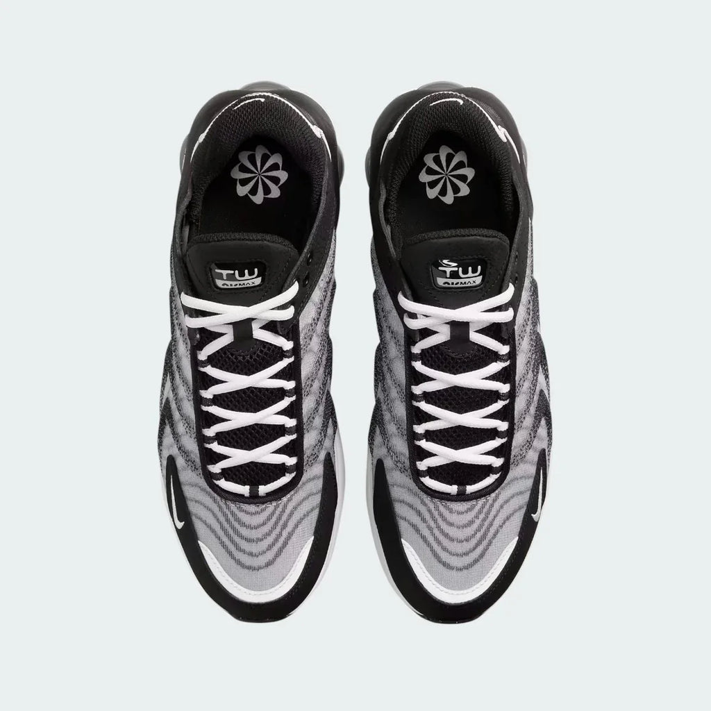 Top-down view of a pair of Nike Air Max TW trainers in black, highlighting the dynamic lace-up system and multi-layered mesh upper texture.