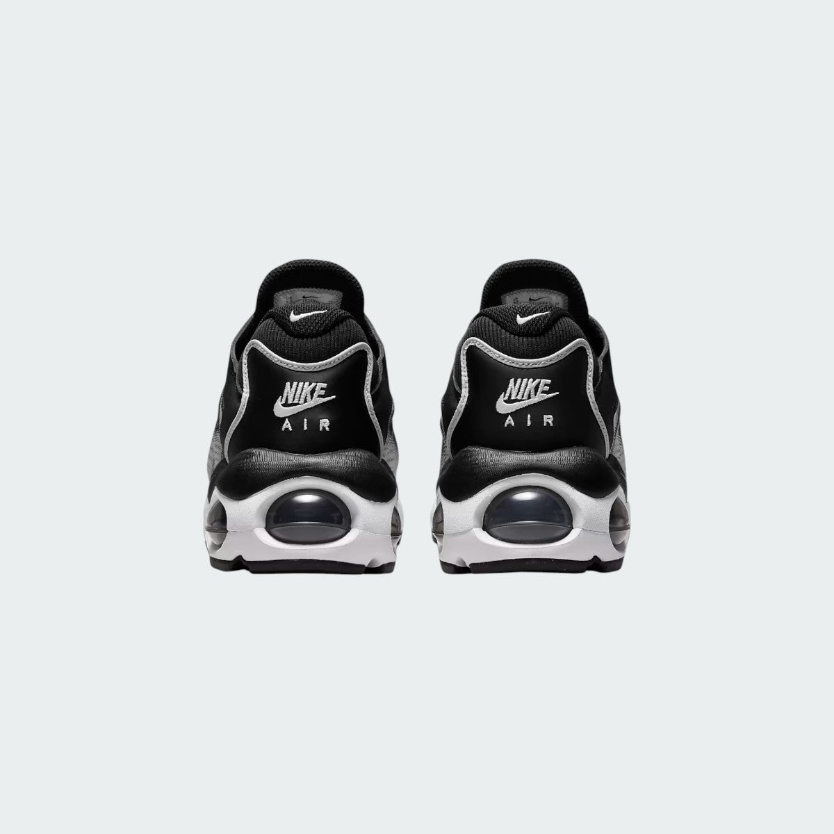 Rear view of the Nike Air Max TW trainers in black, focusing on the prominent, accentuated heel counter and the visible Air cushioning windows.