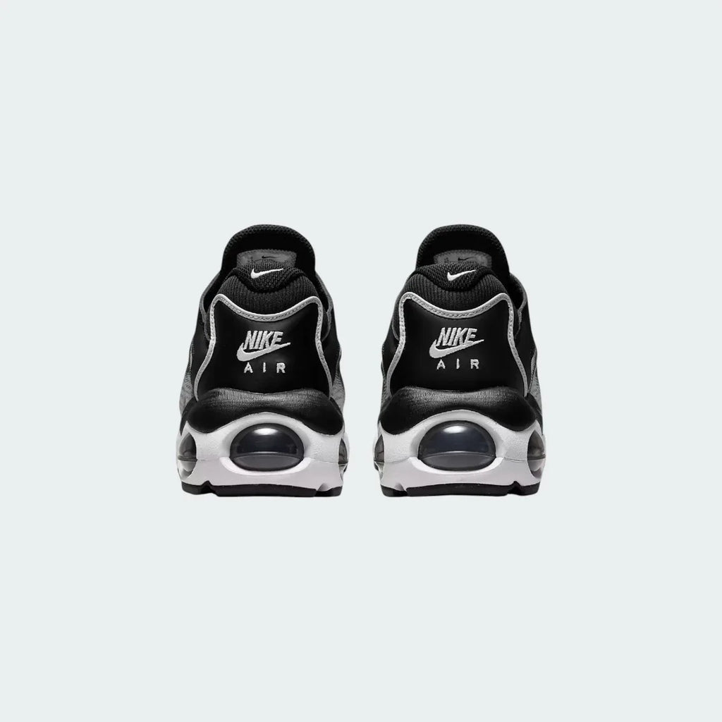 Rear view of the Nike Air Max TW trainers in black, focusing on the prominent, accentuated heel counter and the visible Air cushioning windows.