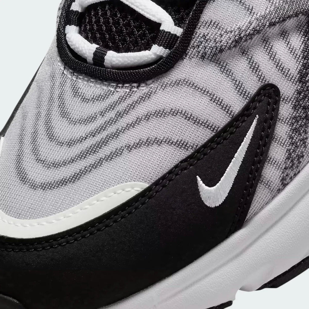 Close-up zoom on the side of the Nike Air Max TW trainers, detailing the haptic texture, angular synthetic overlays, and the visible Air unit.