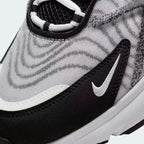 Close-up zoom on the side of the Nike Air Max TW trainers, detailing the haptic texture, angular synthetic overlays, and the visible Air unit.