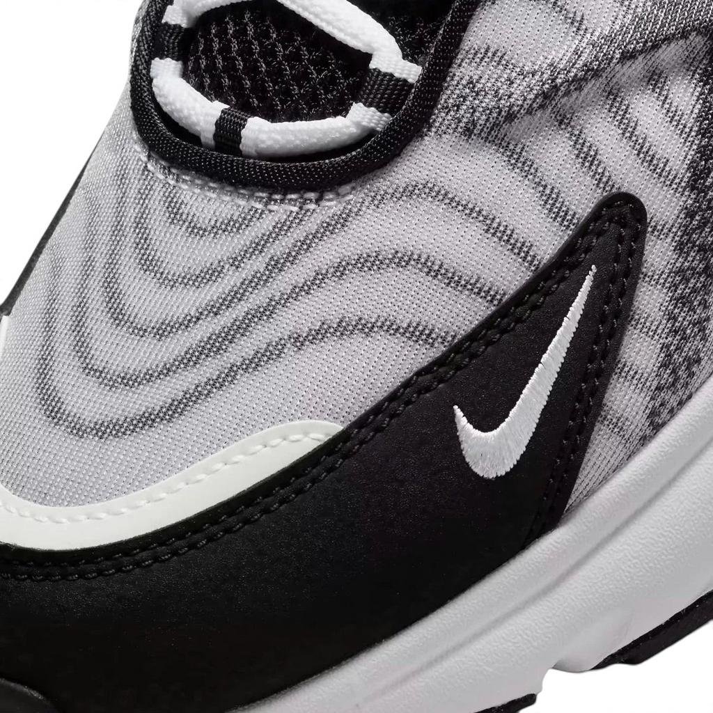 Close-up zoom on the side of the Nike Air Max TW trainers, detailing the haptic texture, angular synthetic overlays, and the visible Air unit.