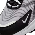 Close-up zoom on the side of the Nike Air Max TW trainers, detailing the haptic texture, angular synthetic overlays, and the visible Air unit.