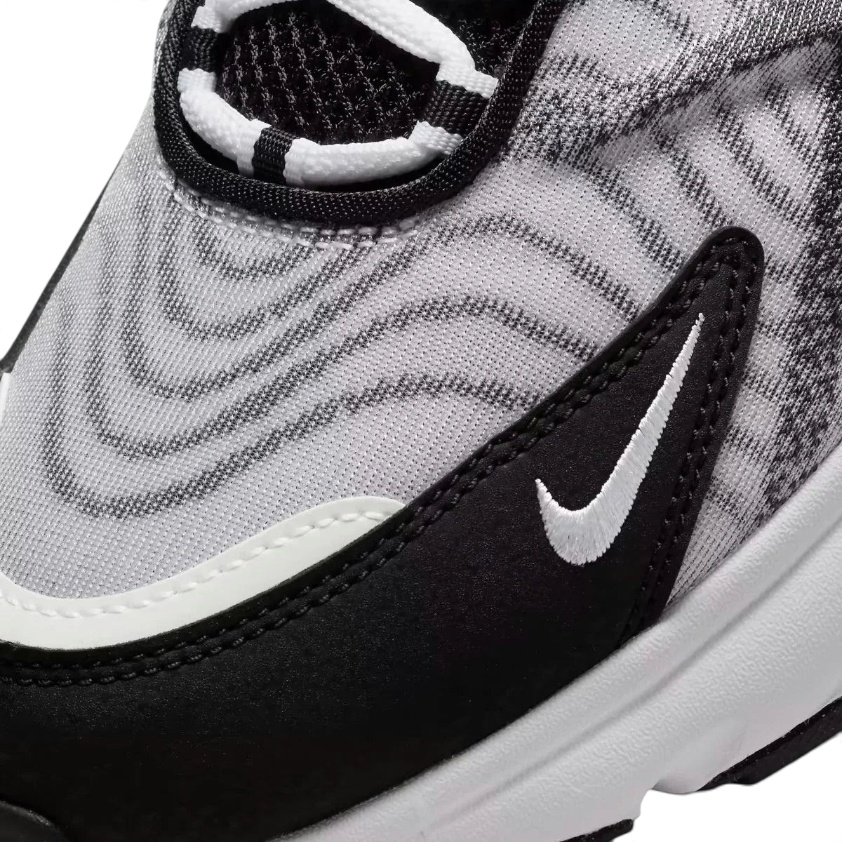 Close-up zoom on the side of the Nike Air Max TW trainers, detailing the haptic texture, angular synthetic overlays, and the visible Air unit.