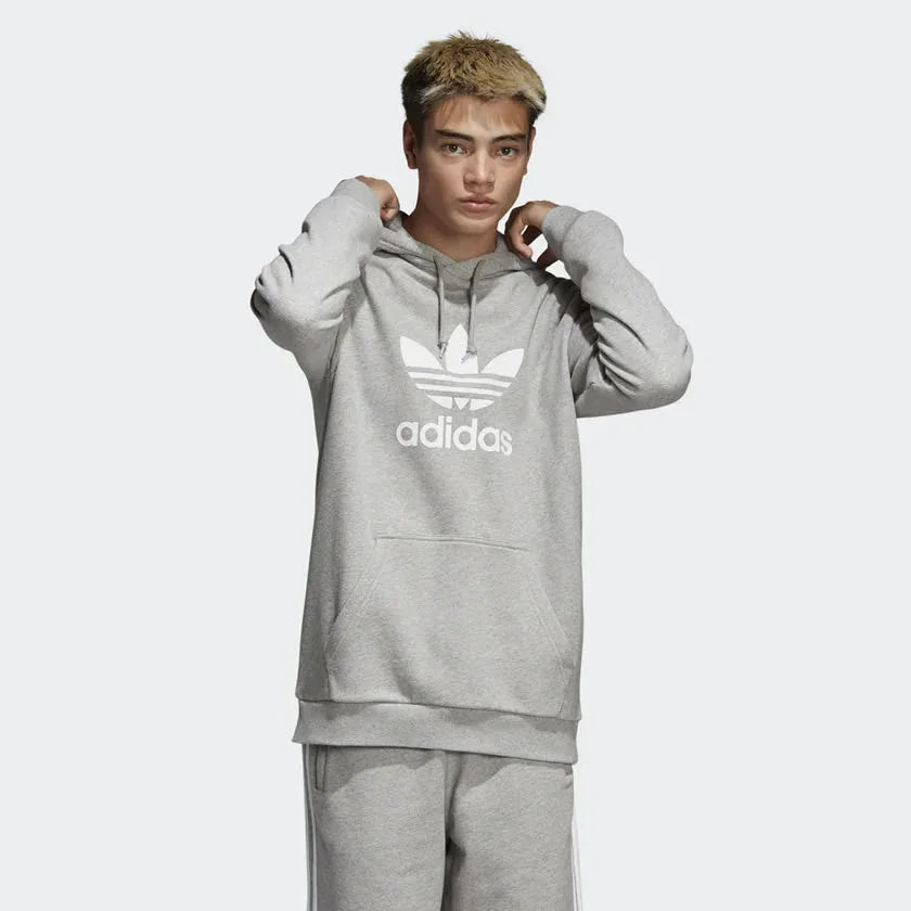 Adidas Trefoil Hoodie Men's in medium grey heather, front view showing large white Trefoil logo on the chest and a kangaroo pocket. model worn Main image
