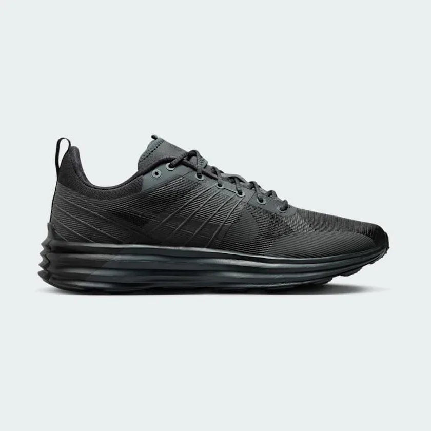Nike Lunar Roam Men's trainers in dark smoke grey and black, side profile showing plush Lunar foam midsole and breathable textile upper. Main image