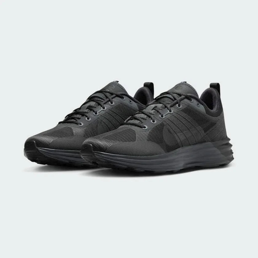 Angled view of two Nike Lunar Roam Men's trainers in dark smoke grey and black, side by side, showcasing their sleek design and chunky sole.